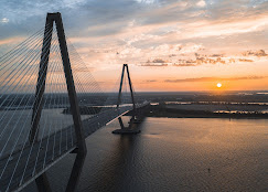 Noah Grove performing guitar near the Ravenel Bridge