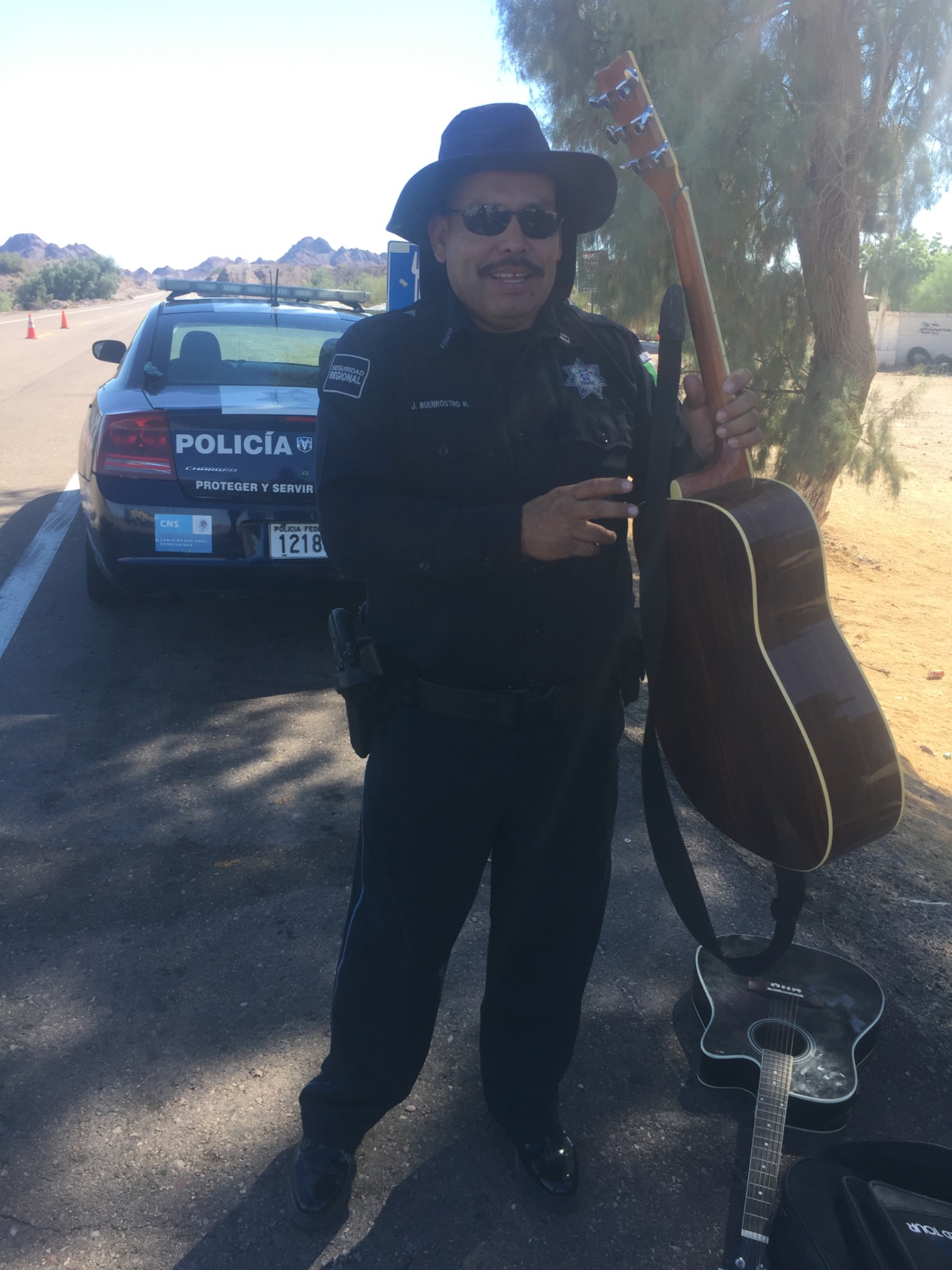 Federales holding guitar